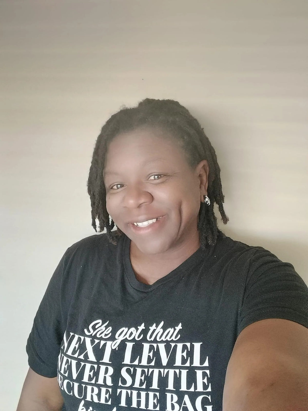 Close-up of the Secure The Bag Vibe tee design in white lettering on black